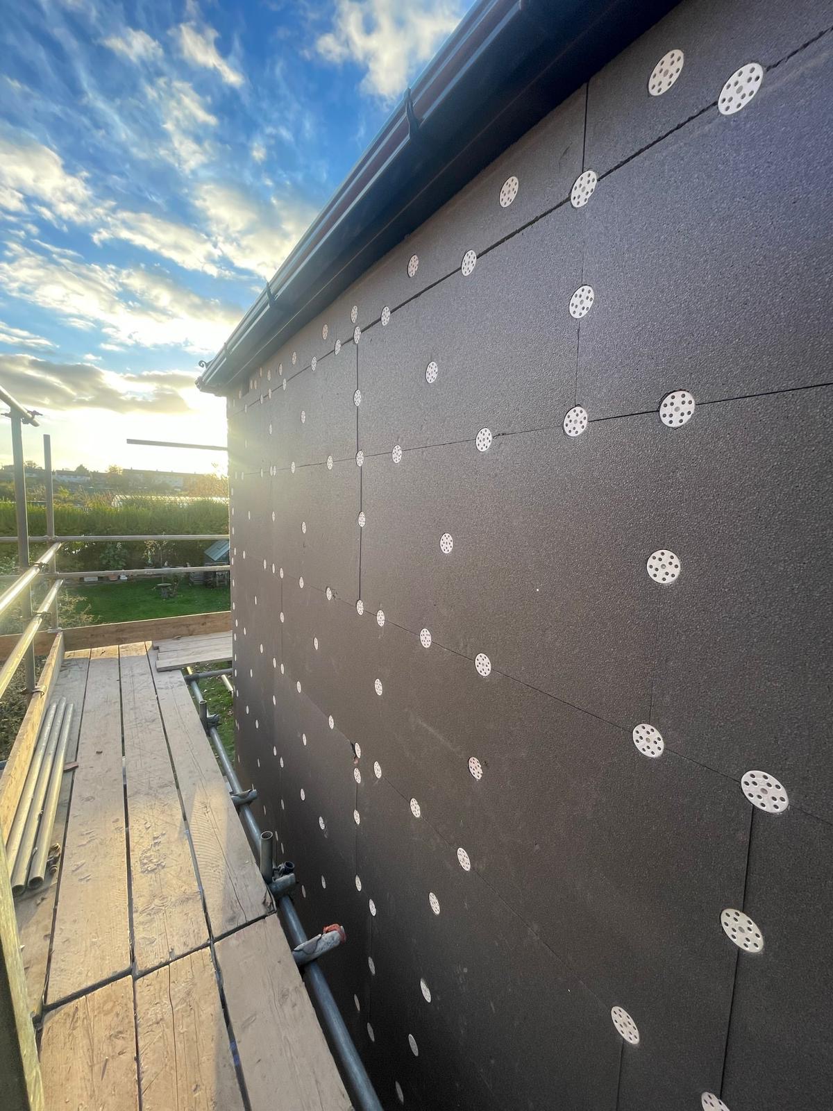 EWI rendering system — panel installation at sunset